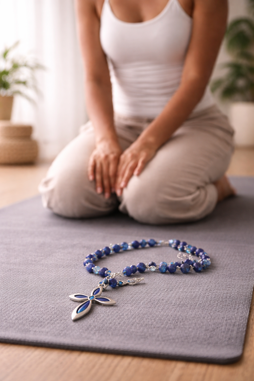 Woman in quiet meditation with lapis lazuli rosary